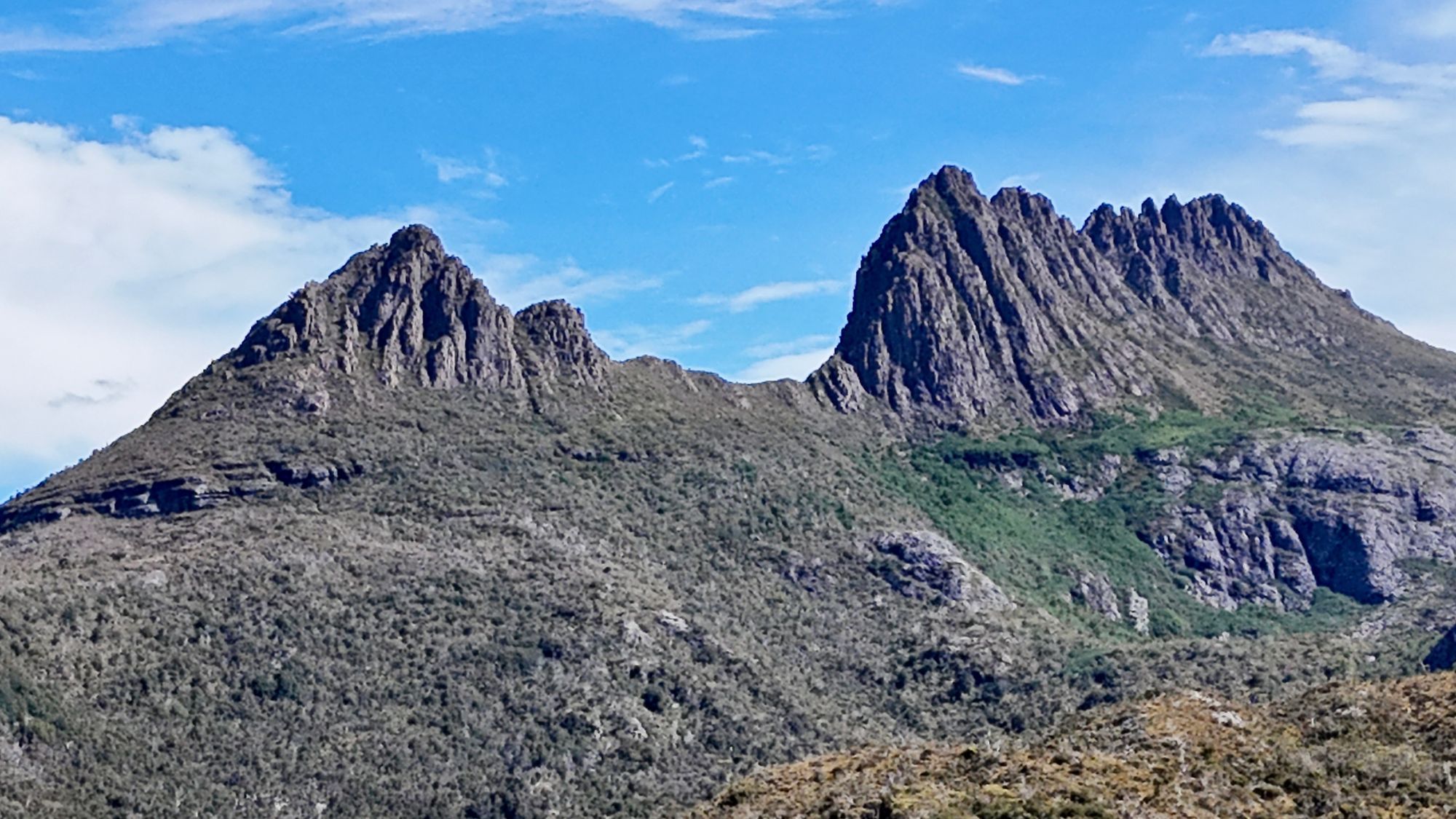 The jagged peaks of Cradle Mountain under a blue sky