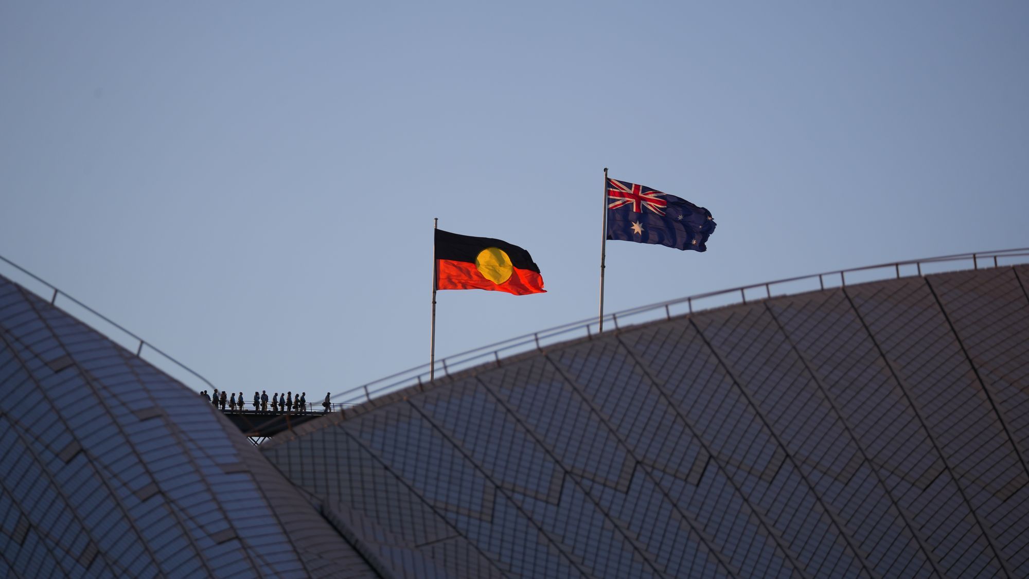 The Aboriginal and Australian flags flying above the Sydney Opera House