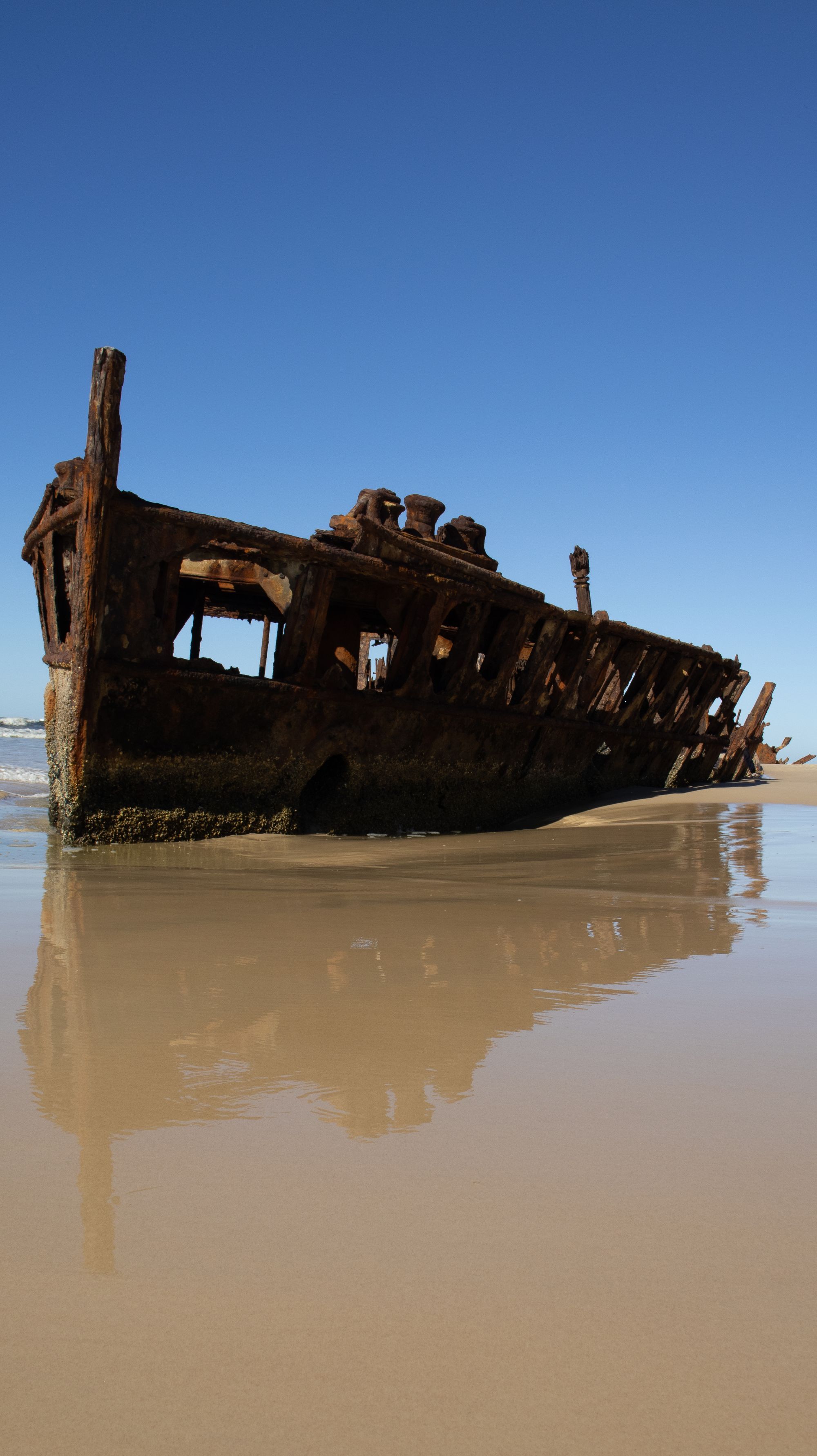 The rusting wreck of the SS Maheno on the beach at K'gari